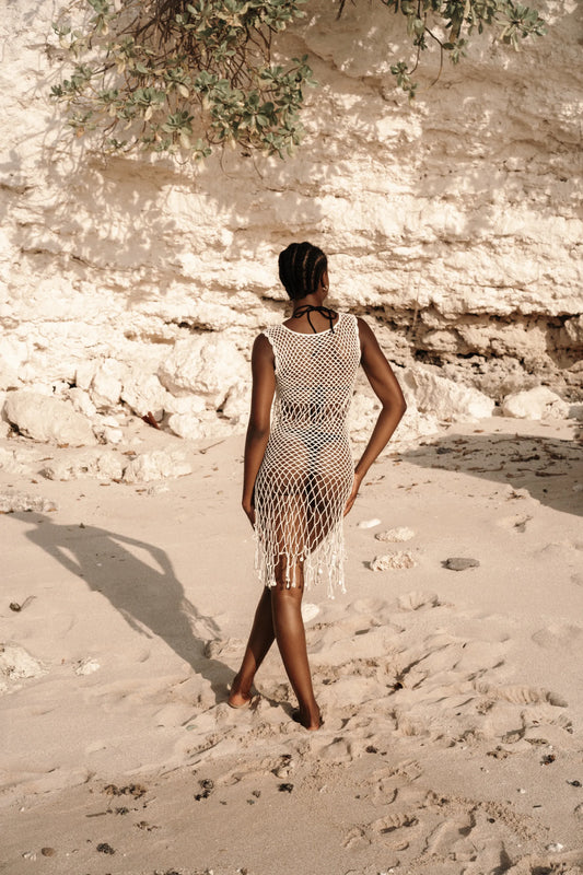 Binar Dress in Ivory - sleeveless fishnet crochet mini with dramatic fringe hem, back view | NYALA