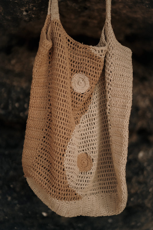 Terra Tote Bag in Cream - large open-weave crochet tote with yin and yang medallion detail, close view | NYALA