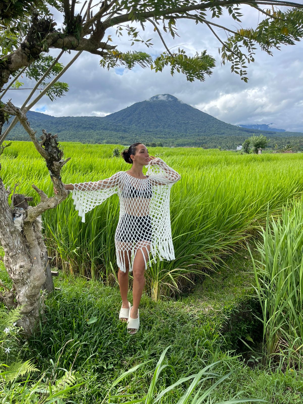 Aoloa Dress in Ivory – diamond net macramé mini with long sleeves, and fringe cuffs, front landscape view | NYALA