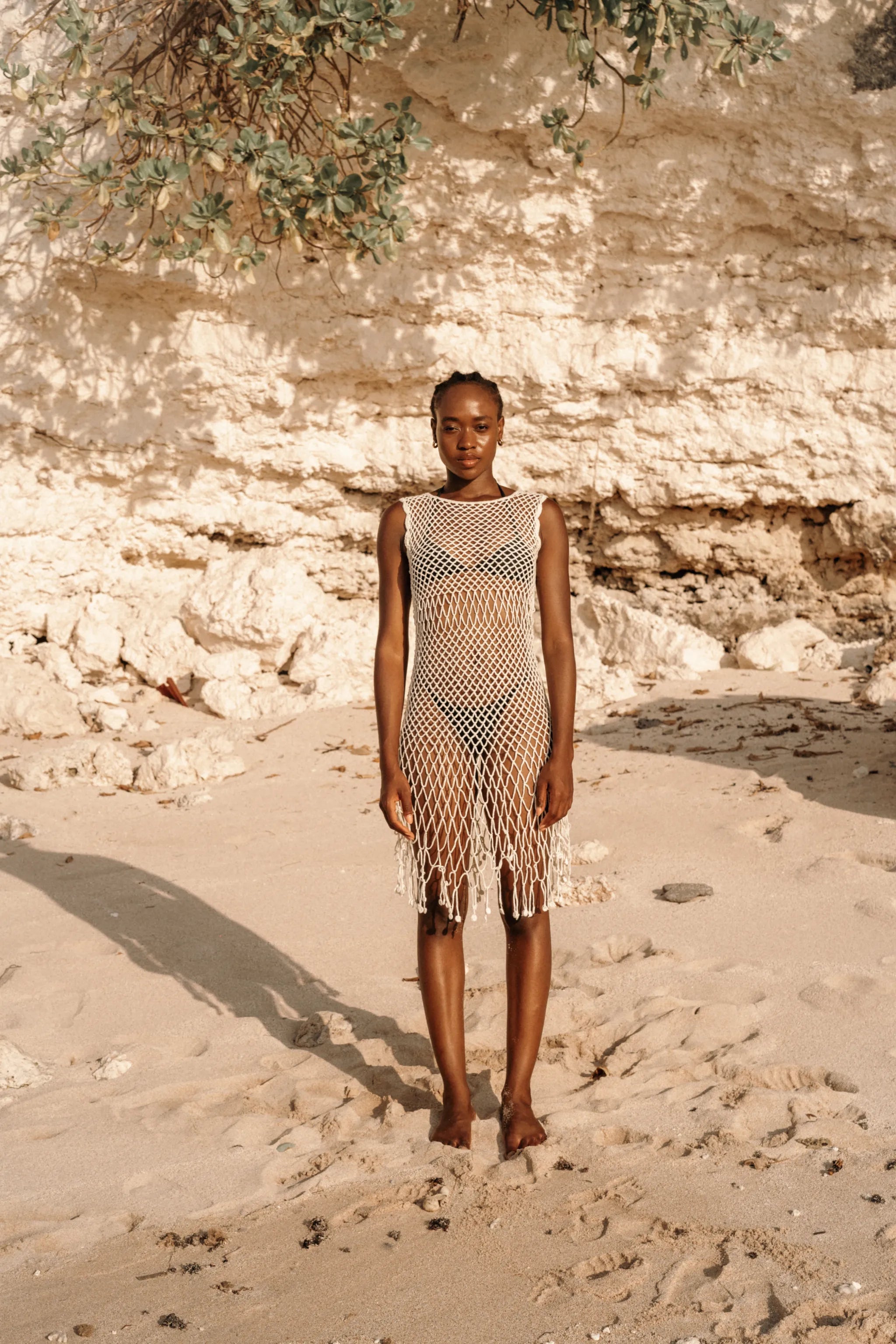 Binar Dress in Ivory - sleeveless fishnet crochet mini with dramatic fringe hem, front view | NYALA
