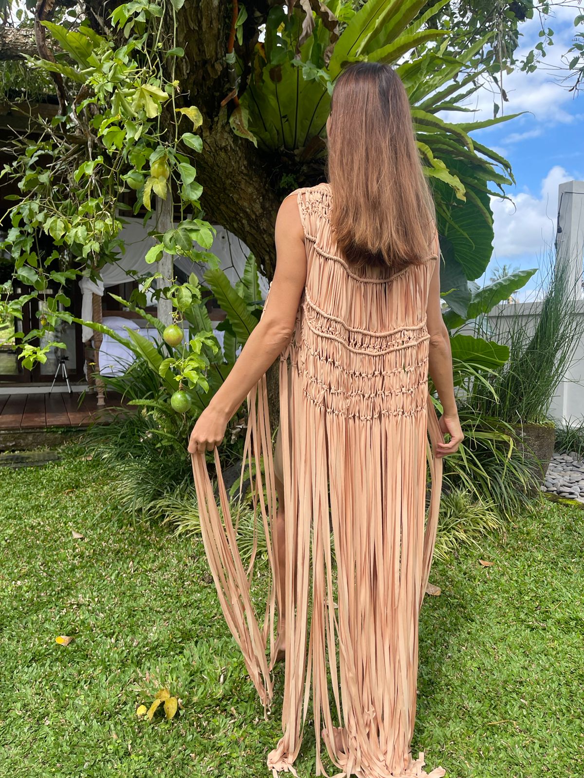 Hawa Vest in Nude - sleeveless macramé open-front vest with intricate knotwork and dramatic floor-length fringe, back view | NYALA