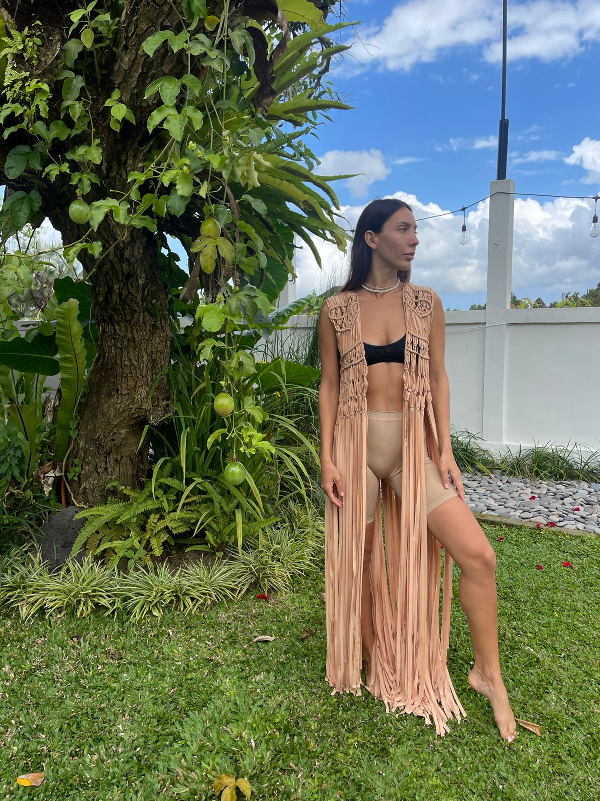 Hawa Vest in Nude - sleeveless macramé open-front vest with intricate knotwork and dramatic floor-length fringe, front view | NYALA