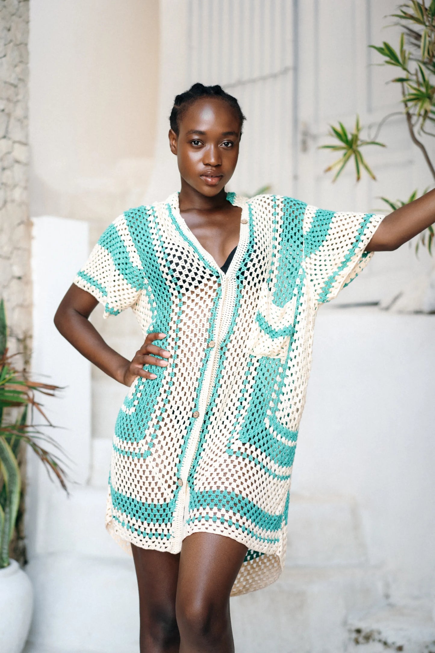 Savera Dress in teal wave motif - loose-fit two-tone crochet mini with button front, patch pockets and V-neckline, front view | NYALA