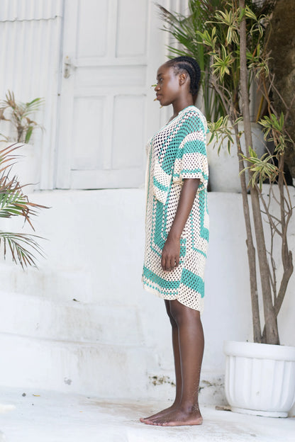Savera Dress in teal wave motif - loose-fit two-tone crochet mini with button front, patch pockets and V-neckline, side view | NYALA