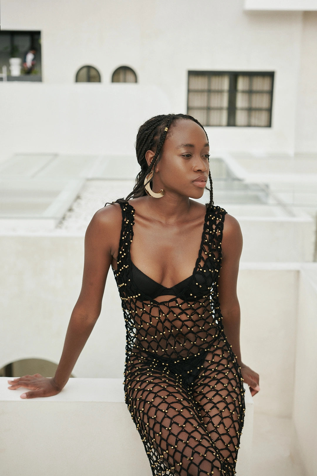 Shristi Dress in Black - form-skimming fishnet crochet maxi with V-neckline, structured bodice and side slit, front close view | NYALA