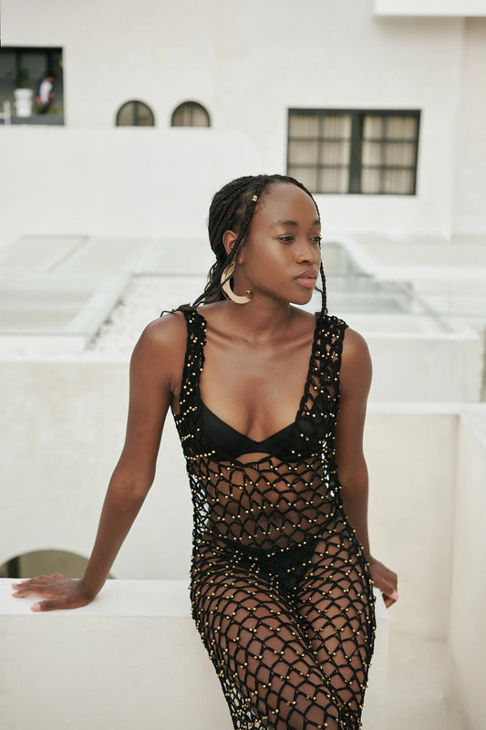 Shristi Dress in Black - form-skimming fishnet crochet maxi with V-neckline, structured bodice and side slit, front close view | NYALA